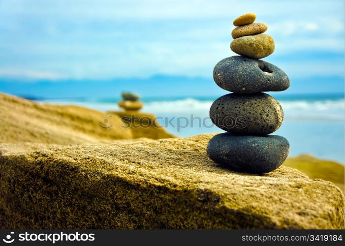 Zen Stone stacked together on blue coud background.