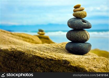 Zen Stone stacked together on blue coud background.