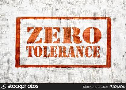 zero tolerance - red graffiti sign on a white stucco wall