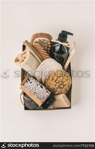 Zero waste beauty body care items on color paper background. Wooden comb, bamboo toothbrushes, reusable cotton pads, soap without package, bamboo and metallic straws, bamboo ear sticks, hand made body lotion, luffa, bamboo massage brash and pumice stone.. Zero waste beauty body care items on color paper background