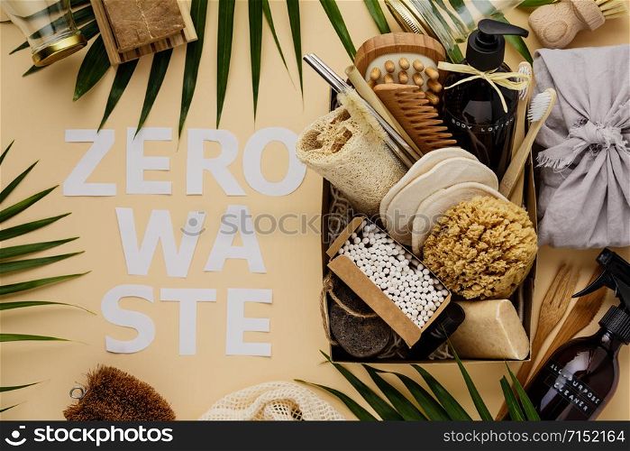 Zero waste beauty body care items on color paper background. Wooden comb, bamboo toothbrushes, reusable cotton pads, soap without package, bamboo and metallic straws, bamboo ear sticks, hand made body lotion, luffa, bamboo massage brash and pumice stone.. Zero waste beauty body care items on color paper background