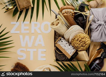 Zero waste beauty body care items on color paper background. Wooden comb, bamboo toothbrushes, reusable cotton pads, soap without package, bamboo and metallic straws, bamboo ear sticks, hand made body lotion, luffa, bamboo massage brash and pumice stone.. Zero waste beauty body care items on color paper background