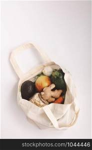 Zero waste concept. Fresh organic fruits and vegetables in cotton eco bag, flat lay