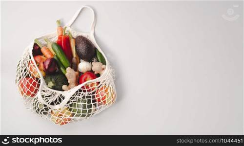Zero waste concept. Fresh organic fruits and vegetables in mesh textile bag