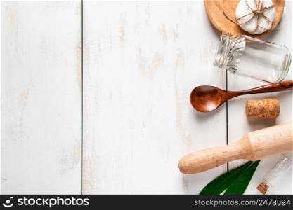 Zero waste concept. Natural recyclable kitchen utensils on a white wooden background. Place for text.. Zero waste concept. Natural recyclable kitchen utensils on a white wooden background.