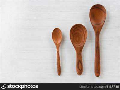 Zero waste kitchen use less plastic concept / Various sizes of wooden spoon and wooden cooked rice ladle on white background