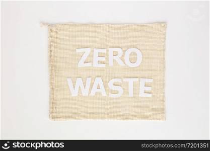 Zero waste paper text on cotton bag, flat lay, top view, white paper background. Zero waste paper text on cotton bag, flat lay