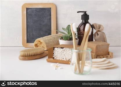 Zero waste, Recycling, Sustainable lifestyle concept. Eco-friendly bathroom accessories: toothbrushes, reusable cotton make up removal pads, make up remover in a glass container, natural brushes, handmade soap, bamboo ear sticks. Zero waste concept. Eco-friendly bathroom accessories, copyspace