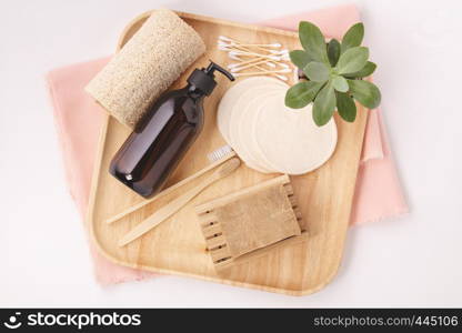 Zero waste, Recycling, Sustainable lifestyle concept. Eco-friendly bathroom accessories: toothbrushes, reusable cotton make up removal pads, make up remover in a glass container, natural brush, bamboo ear sticks, olive oil soap. Flat lay. Zero waste concept. Eco-friendly bathroom accessories, flat lay