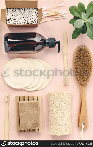 Zero waste, Recycling, Sustainable lifestyle concept. Eco-friendly bathroom accessories: toothbrushes, reusable cotton make up removal pads, make up remover in a glass container, natural brush, bamboo ear sticks, olive oil soap. Flat lay