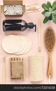 Zero waste, Recycling, Sustainable lifestyle concept. Eco-friendly bathroom accessories: toothbrushes, reusable cotton make up removal pads, make up remover in a glass container, natural brush, bamboo ear sticks, olive oil soap. Flat lay