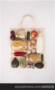 Zero waste shopping concept. Eco bag with fruits and vegetables, glass jars with beans, lentils, pasta. Eco-friendly shopping, flat lay. Zero waste shopping concept, flat lay, top view
