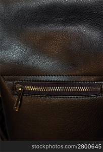Zipper on dark brown leather hand bag