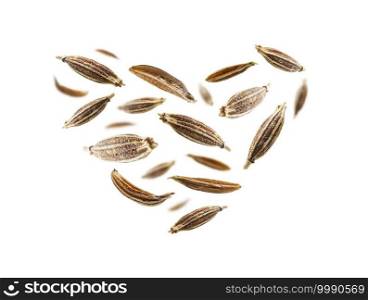 Zira seasoning seeds in the shape of a heart on a white background.. Zira seasoning seeds in the shape of a heart on a white background