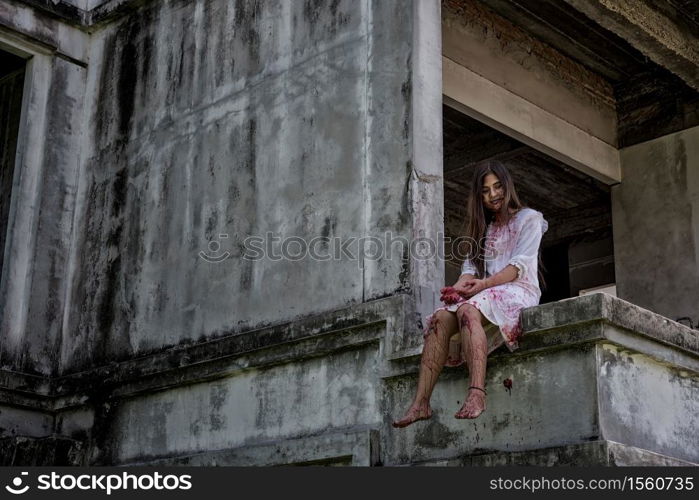 Zombie, Ghost, Woman murder with bloody sit wait for help on abandoned building ,halloween concept