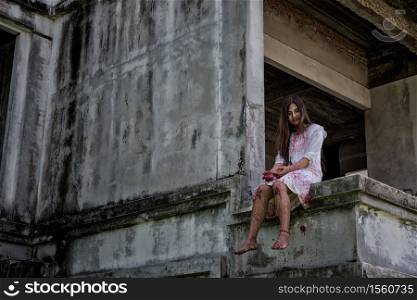 Zombie, Ghost, Woman murder with bloody sit wait for help on abandoned building ,halloween concept