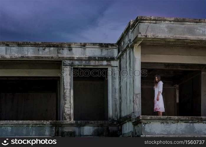 Zombie Ghost woman murder with bloody stand on abandoned building ,halloween concept