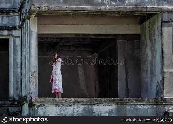 Zombie Ghost woman murder with bloody stand on abandoned building ,halloween concept