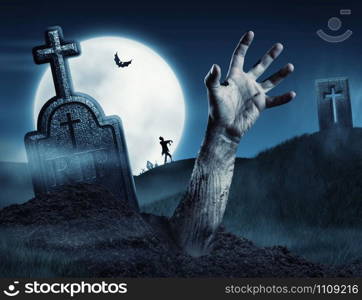 Zombie hand coming out of his grave. Full moon