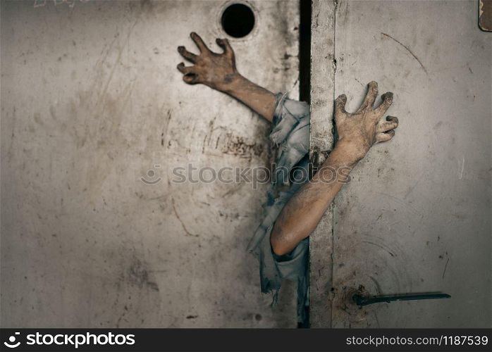 Zombie hands sticking out of the elevator door, deadly chase. Horror in city, creepy crawlies attack, doomsday apocalypse, bloody monsters. Zombie hands sticking out of the elevator door
