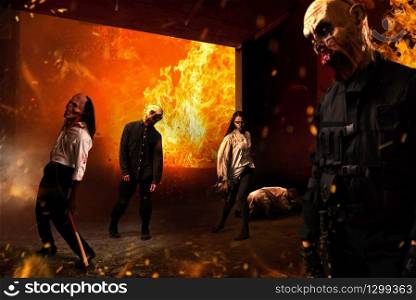 Zombies in a burning movie theater, monsters came alive, explosions and fire on background. Horror in city, creepy crawlies attack, apocalypse