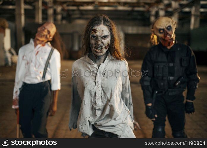 Zombies looking for fresh meat in abandoned factory, scary place. Horror in city, creepy crawlies attack, doomsday apocalypse, bloody evil monsters. Zombies looking for fresh meat, abandoned factory