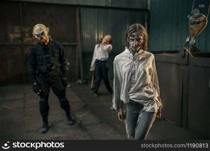 Zombies looking for fresh meat in abandoned factory, scary place. Horror in city, creepy crawlies attack, doomsday apocalypse. Zombies looking for fresh meat, abandoned factory