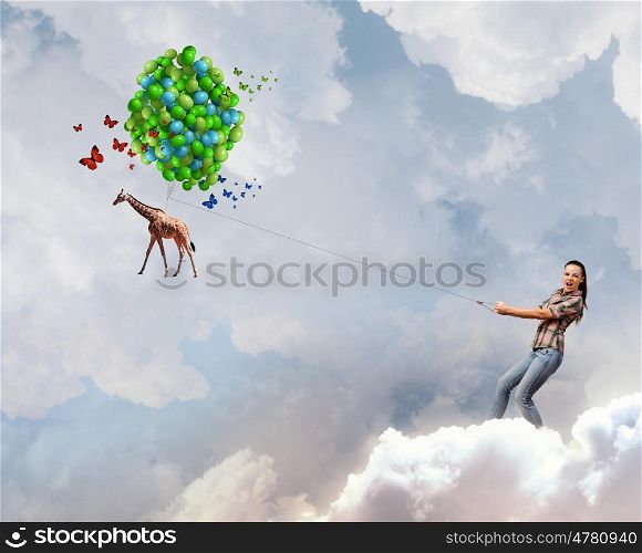 Zoo animal. Young woman in casual and giraffe on lead
