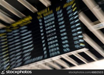Zoom effect departures check in board at an airport