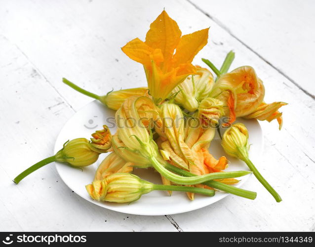 zucchini flowers in a white plate on a table