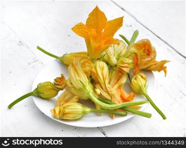 zucchini flowers in a white plate on a table