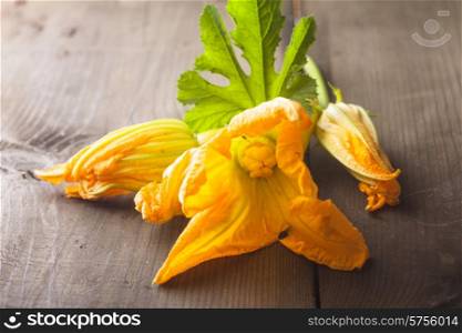 zucchini flowers on a wooden table close up