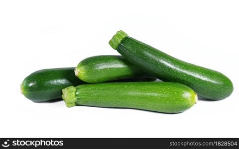 Zucchini green vegetables isolated on white background close up view of four fresh organic baby zucchini.
