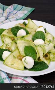 Zucchini salad with mozzarella, olives, dill and mint