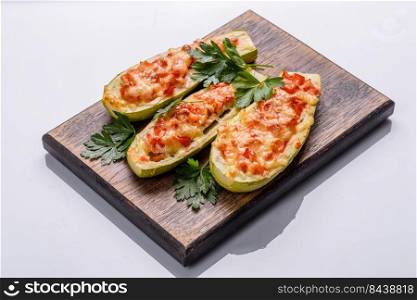 Zucchini stuffed with meat, vegetables and cheese. Zucchini boats. Loaded zucchini. Baked stuffed zucchini boats with minced chicken mushrooms and vegetables with cheese