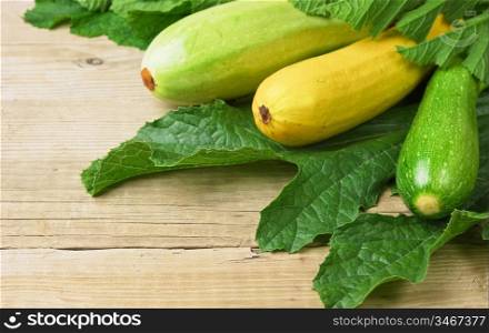 zucchini with leaves on a wooden table