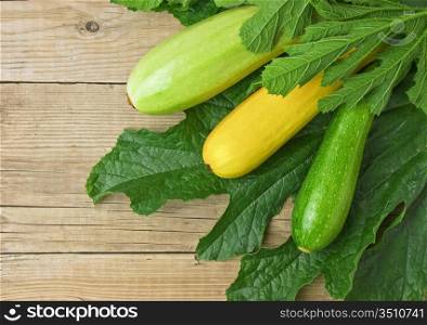 zucchini with leaves on a wooden table