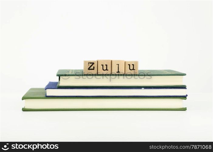 zulu word on wood stamps stack on books, language and study concept
