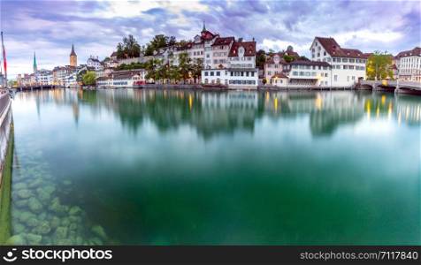 Zurich. Panoramic view of the city promenade and the facades of medieval houses at dawn. Switzerland.. Zurich. Scenic panoramic view of the city promenade and at dawn.